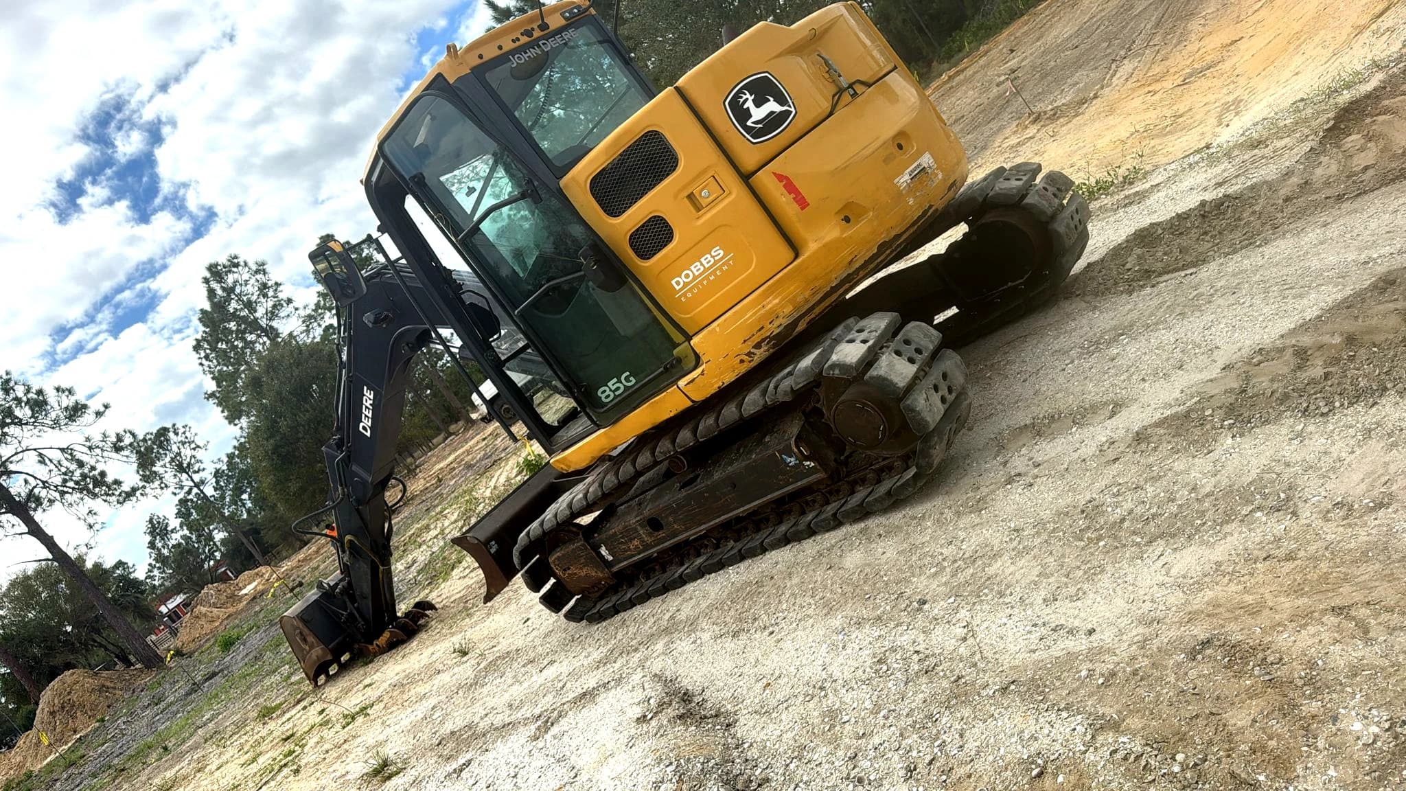 Professional land clearing service in Florida by Vreeland Roofing. Heavy-duty John Deere excavator preparing land for construction and development. Expert site preparation, grading, and lot clearing solutions.